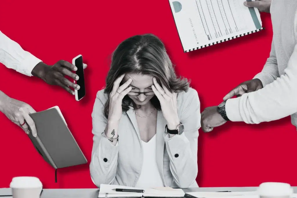 Stressed employee overwhelmed by multiple tasks, representing Sanofi's urgent need for scale software automation and integration with OPCenter software to eliminate manual data entry and reduce errors.