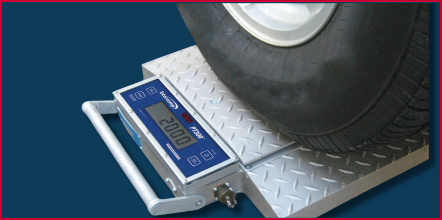 Close-up of a portable wheel weigher rental scale measuring a vehicle tire, ideal for quick and accurate wheel or axle weight assessments in logistics, construction, and compliance applications