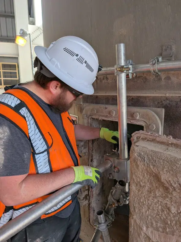 Technician performing detailed asset inspection for predictive maintenance