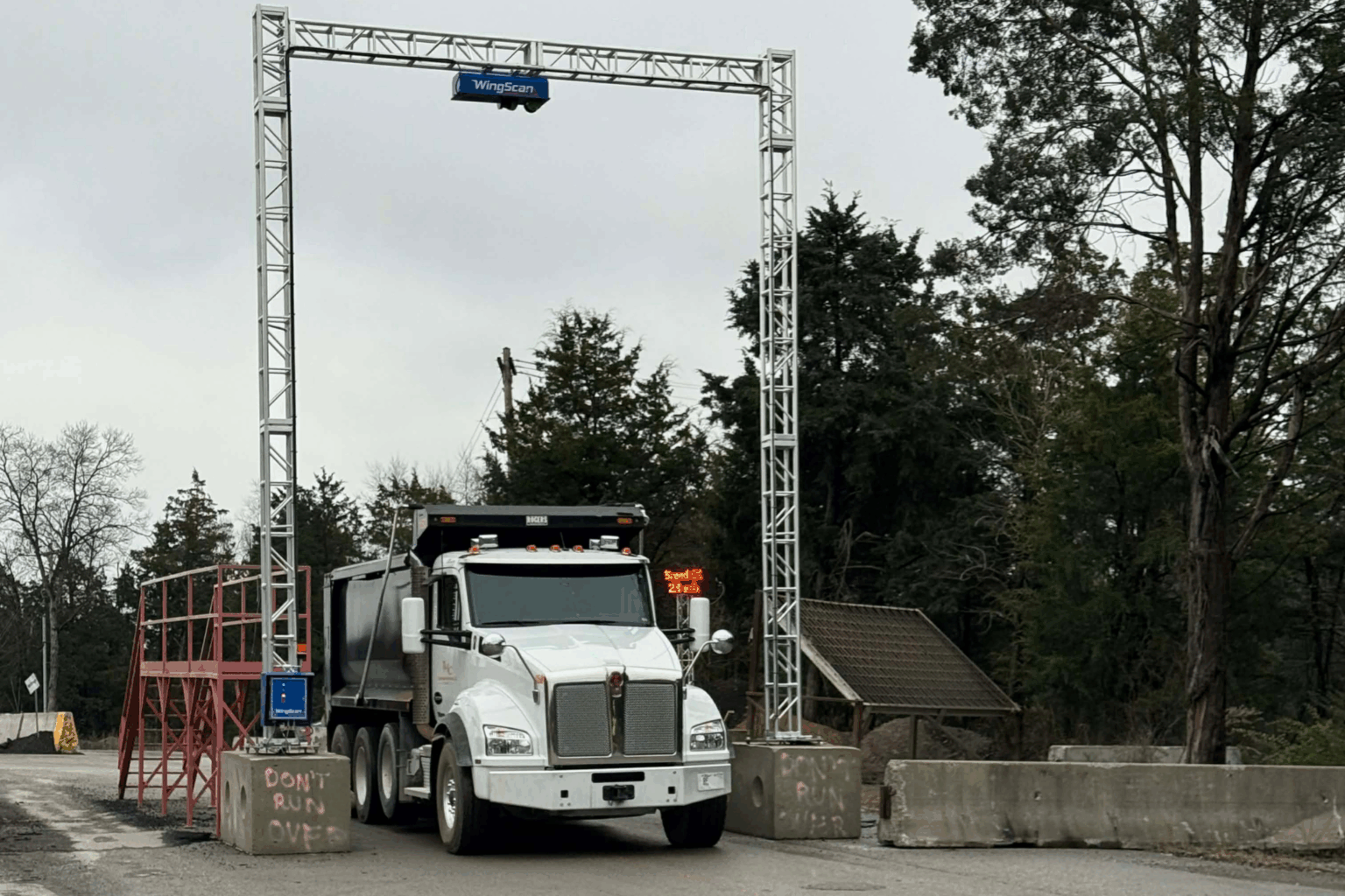 Dump truck beneath Wingfield’s WingScan-T load scanner during NTEP field testing.